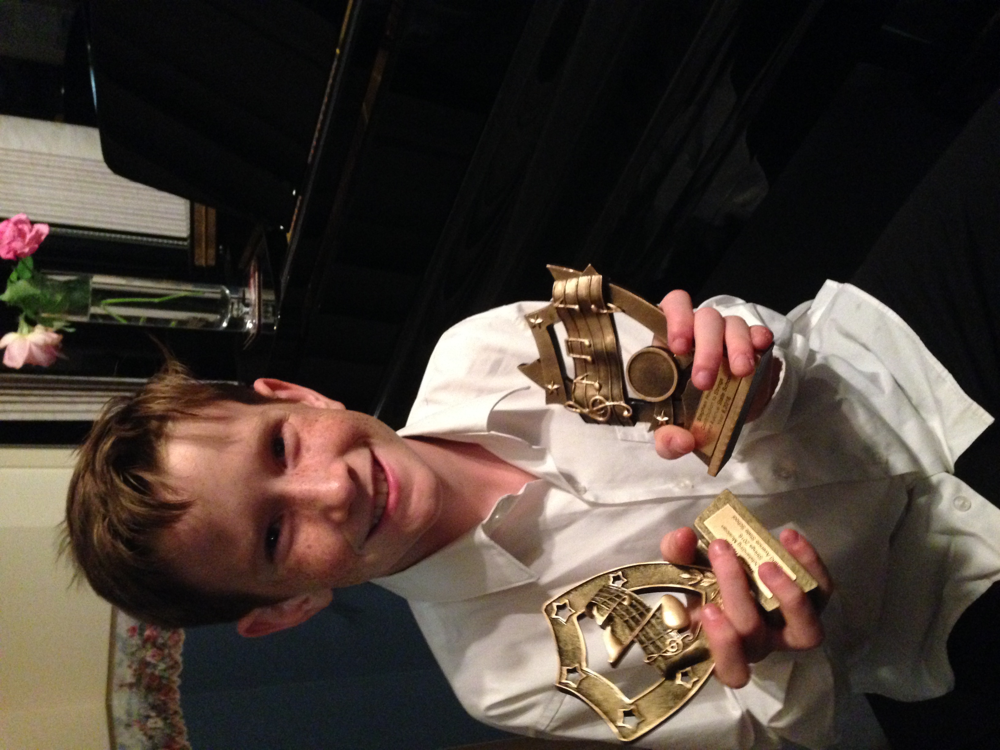 Student holding trophies